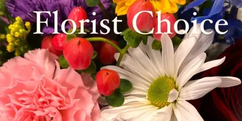 A colorful floral arrangement featuring a sunflower, red roses, pink carnations, and white daisies.