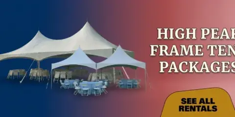 A white high peak frame tent set up outdoors with tables and chairs arranged underneath.
