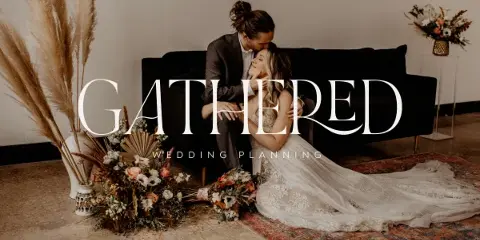 A wedding couple sitting on a black sofa surrounded by floral arrangements with the text 'GATHERED WEDDING PLANNING' overlaid.