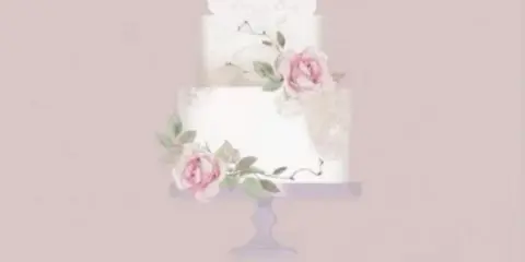 A three-tiered white wedding cake decorated with pink roses and greenery on a pedestal stand.