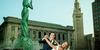 A bride and groom dancing in front of the Cleveland City Hall and Terminal Tower.