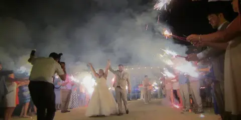 A bride and groom walking through a sparkler tunnel at a wedding reception at Shadowland Ballroom in St. Joseph, MI.