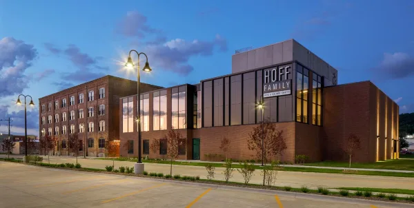 Exterior view of the Hoff Family Arts & Culture Center building at dusk