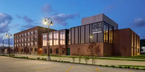 Exterior view of the Hoff Family Arts & Culture Center building at dusk