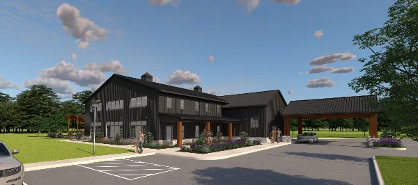 Exterior view of the Ember Wood Events venue building with a parking lot and green lawn.