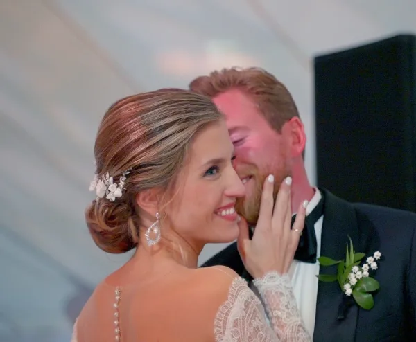 A bride and groom sharing an intimate moment at their wedding reception.