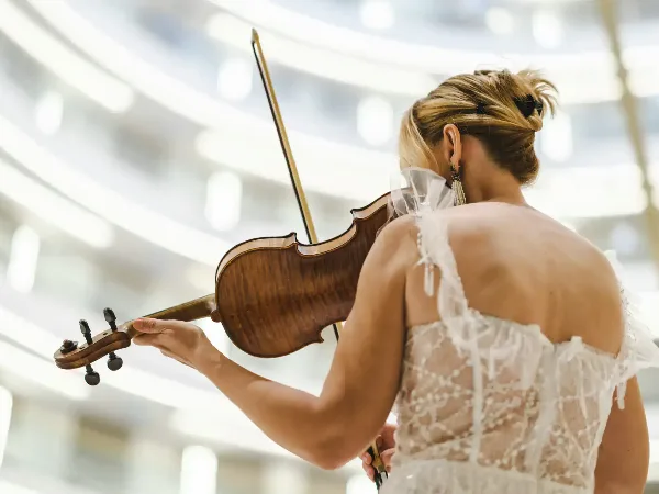 A musician playing a violin at a wedding event.
