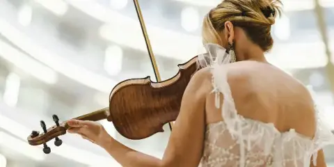 A musician playing a violin at a wedding event.