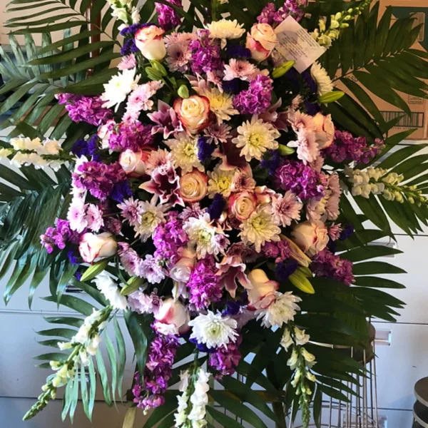 Large standing floral spray with purple, pink, and white flowers