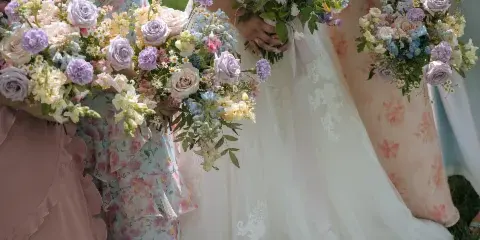Bride and bridesmaids holding colorful floral bouquets