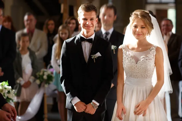 A bride and groom standing together at a wedding ceremony.