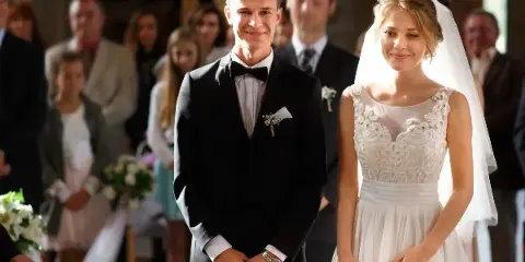 A bride and groom standing together at a wedding ceremony.