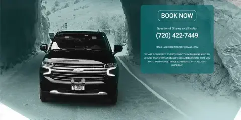A black Chevrolet SUV driving on a paved road through a rocky mountain landscape.
