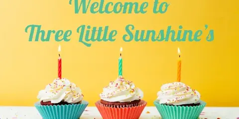 Three cupcakes with white frosting and lit candles on a yellow background with the text 'Welcome to Three Little Sunshine's'.