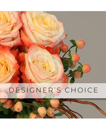 A floral arrangement featuring peach and white roses with green foliage and berries.