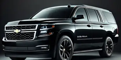 A black Chevrolet Suburban SUV parked against a dark background.