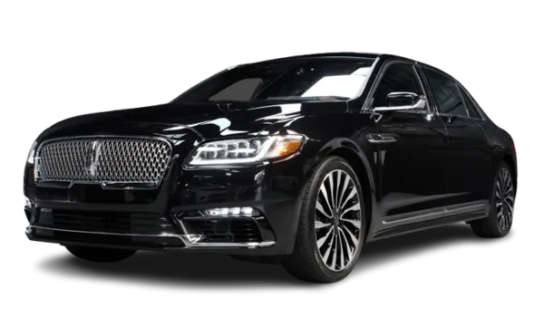 A black luxury sedan, likely a Lincoln Continental, photographed against a black background.