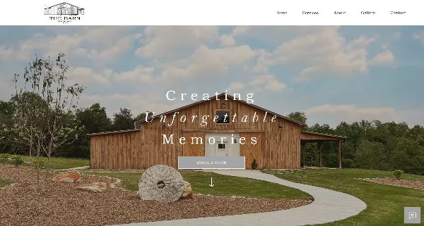Exterior view of a large wooden barn wedding venue with a paved driveway and landscaped grounds.