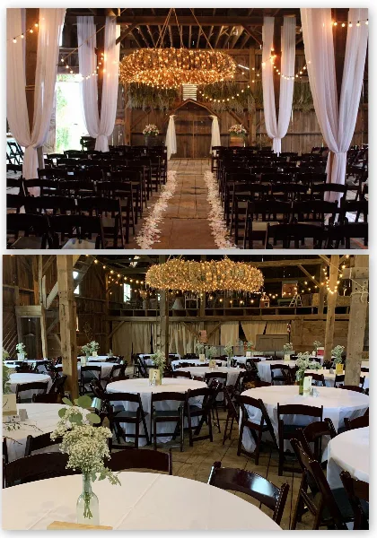 Interior of a rustic barn venue decorated with white drapery, string lights, and a large chandelier, set up with rows of chairs for a ceremony and round tables for a reception.