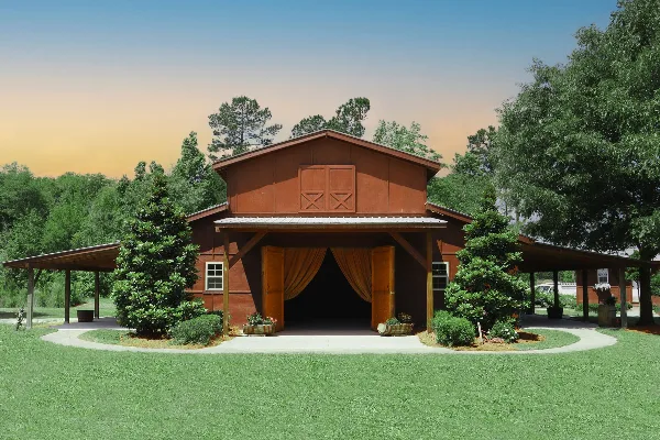 Rustic red barn wedding venue with open doors, outdoor pavilion, and landscaped grounds at sunset.