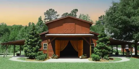 Rustic red barn wedding venue with open doors, outdoor pavilion, and landscaped grounds at sunset.