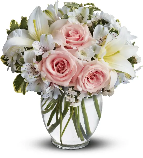A floral arrangement featuring pink roses, white lilies, and alstroemeria in a clear glass vase.
