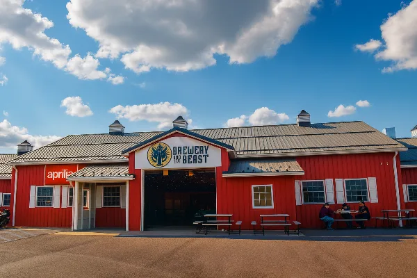 Exterior view of the red Brewery and the Beast building with its logo on the front facade.