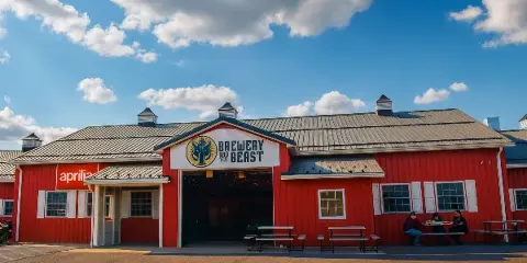Exterior view of the red Brewery and the Beast building with its logo on the front facade.