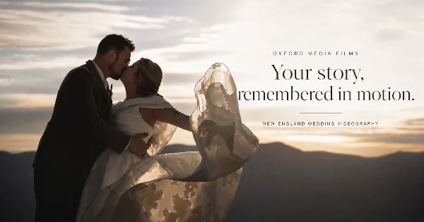 A cinematic wedding photograph of a couple kissing at sunset with the text 'Oxford Media Films' and 'Your story, remembered in motion.'