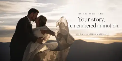 A cinematic wedding photograph of a couple kissing at sunset with the text 'Oxford Media Films' and 'Your story, remembered in motion.'