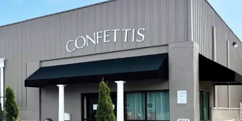 Exterior view of the Confetti's Event Center building with signage and address number 1913.