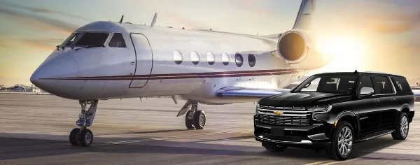 A black luxury SUV parked on a tarmac next to a private jet.