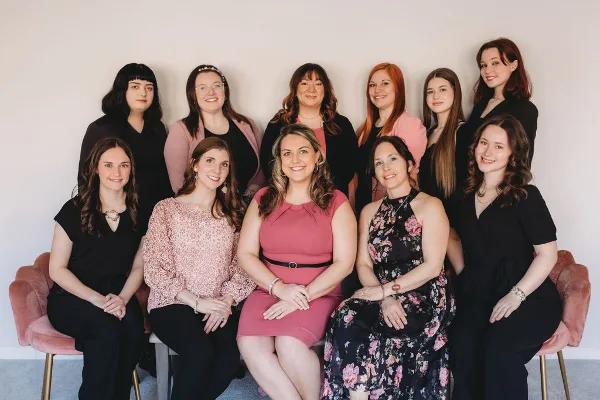 A professional group portrait of the aRay of Events wedding planning team.