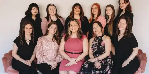 A professional group portrait of the aRay of Events wedding planning team.