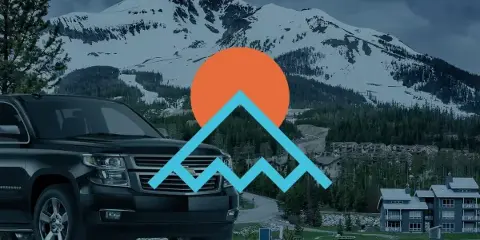 A black Chevrolet Suburban SUV parked in front of a snowy mountain landscape with a mountain logo overlay.
