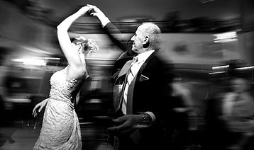 A bride and groom dancing at a wedding reception.