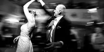 A bride and groom dancing at a wedding reception.
