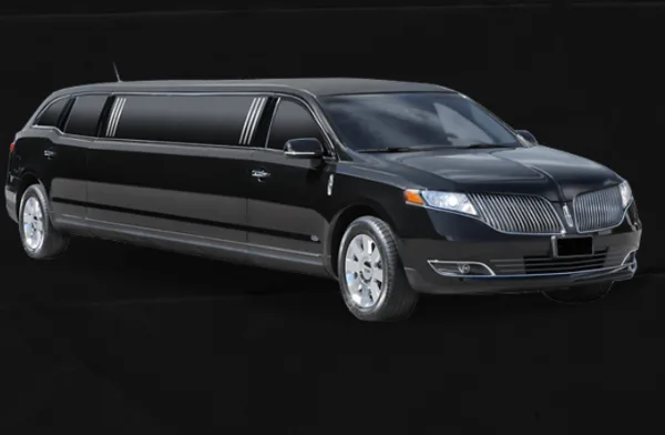 A black stretch limousine parked against a dark background.