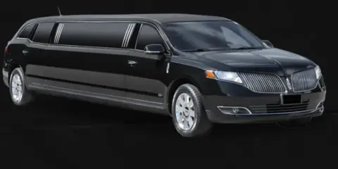 A black stretch limousine parked against a dark background.