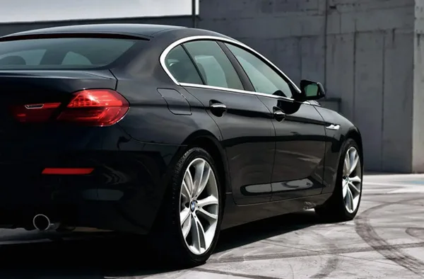 A black luxury sedan parked outdoors.