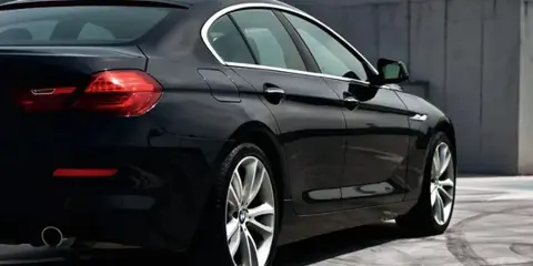 A black luxury sedan parked outdoors.