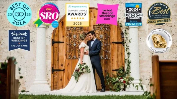 A bride and groom standing in front of a large wooden door with decorative ironwork and stone columns at a wedding venue.