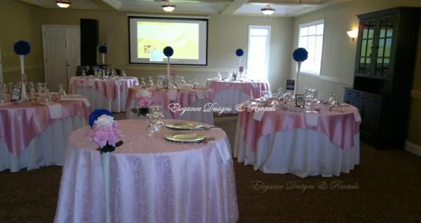 Reception tables with pink linens and floral decorations