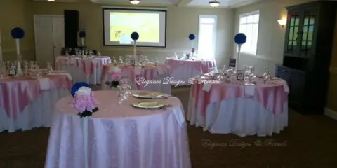 Reception tables with pink linens and floral decorations