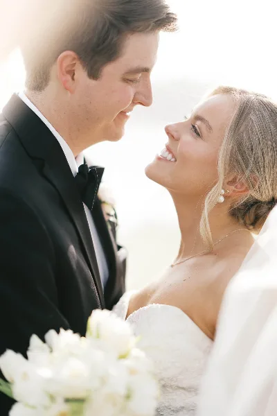A bride and groom looking at each other affectionately during their wedding.
