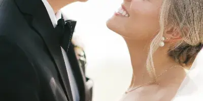 A bride and groom looking at each other affectionately during their wedding.