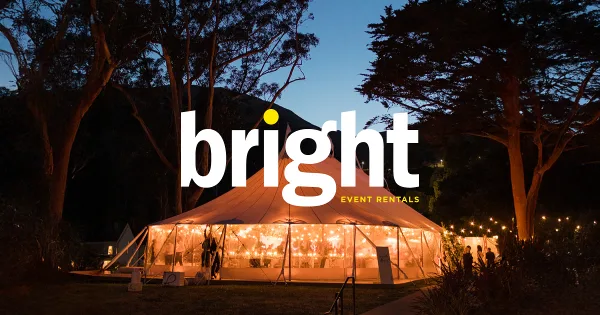 An illuminated white event tent set up outdoors at dusk with the Bright Event Rentals logo overlaid.