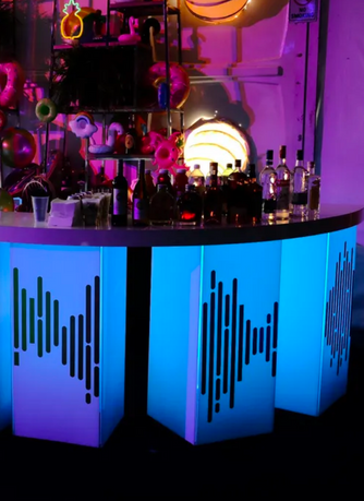 Illuminated blue LED bar with custom decal panels and bottles on top