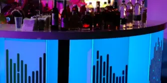 Illuminated blue LED bar with custom decal panels and bottles on top