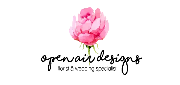 A single pink flower with a green stem on a black background
